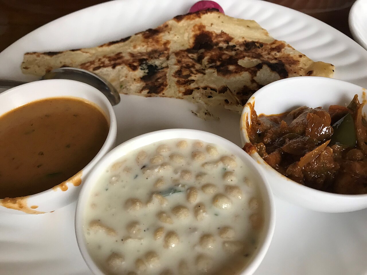 Full Indian thali with assorted curries, breads and sides